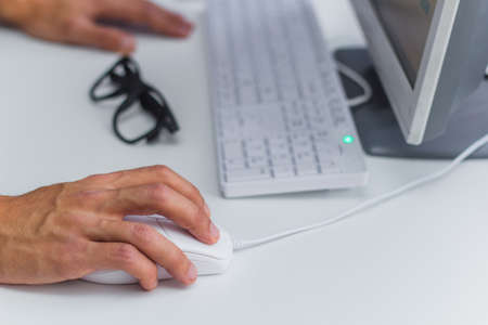 modern office man working at a computer, close up hand on the mouse