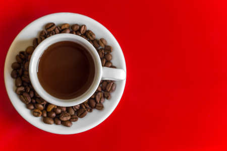 white coffee mug on a red background. top view. copy space.の写真素材