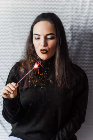 beautiful young brunette with sparkler at the party