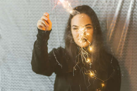 girl (defocused)  with sparkler at the party.の写真素材