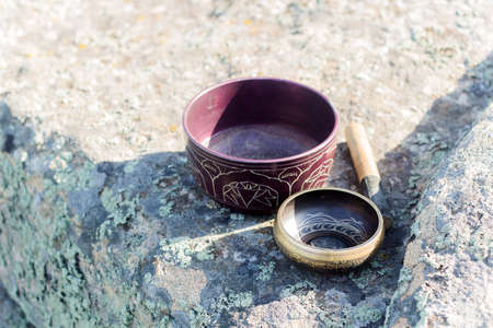 two singing bowls on a stone backgroundの写真素材
