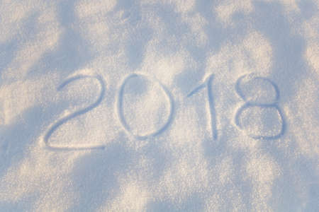 inscription 2018 on snow surface top view