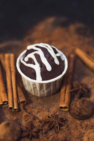homemade spicy chocolate cupcake , sweets and spices mess on the table