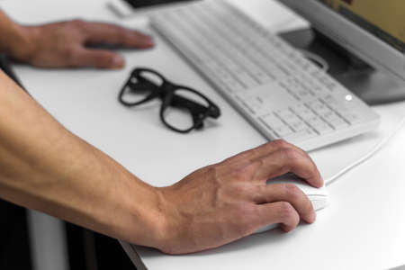 modern office man working at a computer, close up hand on the mouseの写真素材