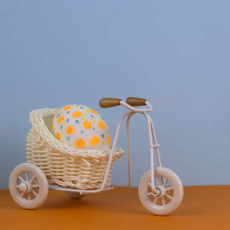 small decorative bicycle with polka dot egg orange  blue backgroundの写真素材