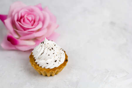 top view vanilla cupcake and blurred rose copy spaceの写真素材