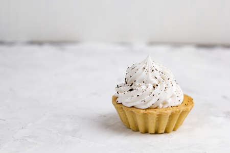 cupcake with cream decorated with chocolate chips concrete backgroundの写真素材