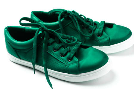 close up pair of green sneakers isolated on whiteの写真素材