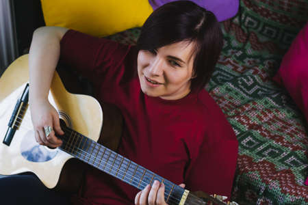 beautiful young woman playing guitar
