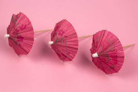 top view cocktail umbrellas pattern pink backgroundの写真素材
