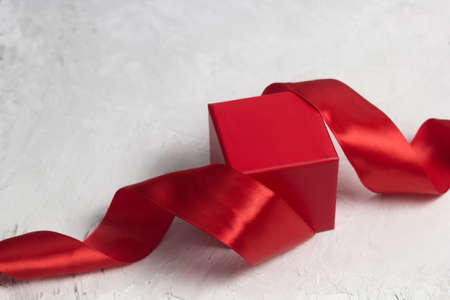 red gift box with red satin ribbon top viewの写真素材
