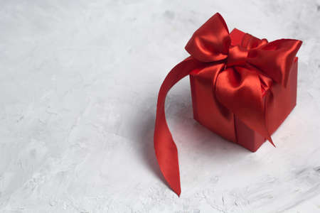 red gift box with red satin ribbon top viewの写真素材