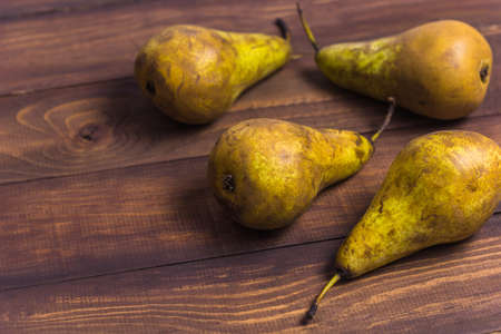 four pears on a wooden table copy spaceの写真素材