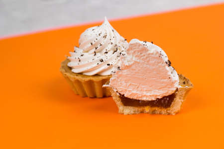 homemade sweet cupcakes with whiped cream and apricot jamの写真素材