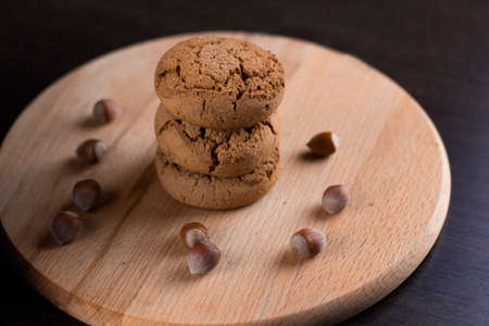 oatmeal cookies with hazelnuts wooden backgroundの写真素材