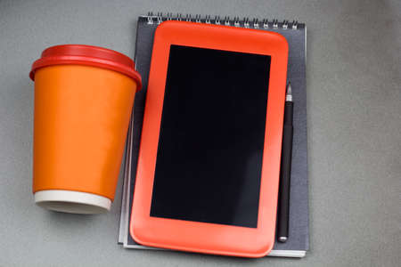 top view coffee to go cup, tablet and notepad