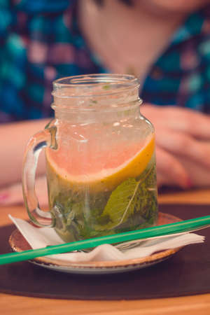 mojito cocktail in a glass jar on cafe tableの写真素材