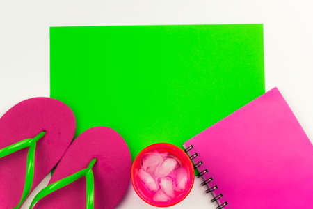 summer flat lay with flip flops,notebook and cold drink with ice