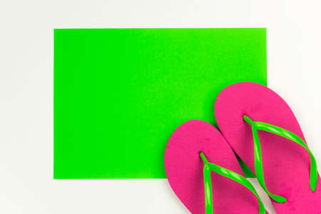 summer bright pink flip flops green backgroundの写真素材
