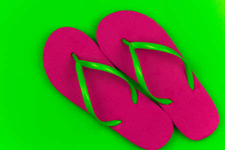 summer bright pink flip flops green backgroundの写真素材