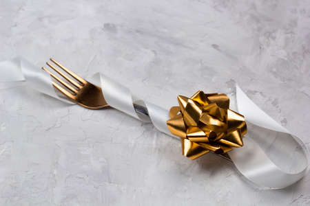 fork decorated with white satin ribbon for wedding ,christmas or other celebrationsの写真素材