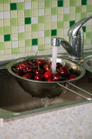 washing cherries before eatingの写真素材