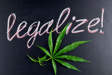 top view marihuana leaf with inscription legalize on a chalkboard