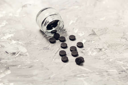 coal and activated carbon tablets on the tableの写真素材