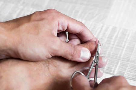 nail clipping, close up trimming toenails