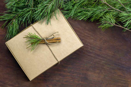 top view pine brances frame, gift box, wooden background, copy spaceの写真素材