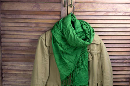 coat with scarf on the hanger, vintage closet for the backgroundの写真素材
