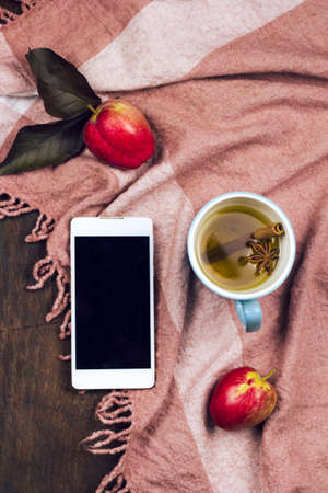 top view phone with empty black screen and hot spicy apple tea