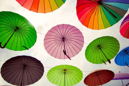 street  decoration with bright umbrellas against the skyの写真素材