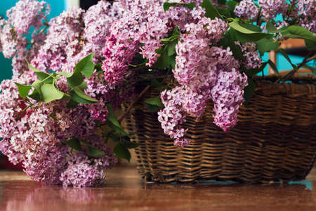 Lilac flowers bunch in a vintage brown basketの写真素材