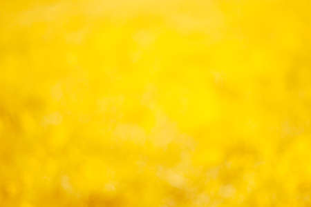 shiny vibrant blurred  yellow and orange bokeh backgroundの写真素材