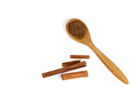 top view of a spoon of sandal wood with cinnamon  isolated on white background