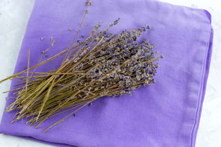 top view dry lavender flowers on a violet napkinの写真素材
