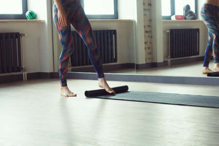 woman rolling yoga matの写真素材