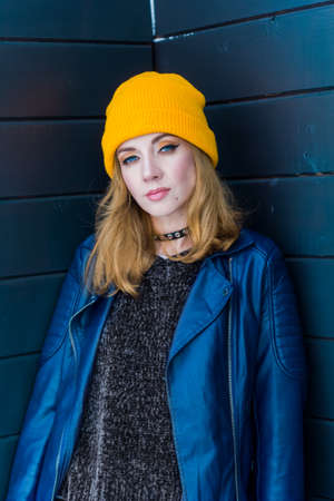 beautiful woman in yellow hat and blue jacketの写真素材