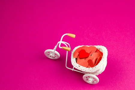 cute trinket retro bike with white wicker basket full of red paper hearts