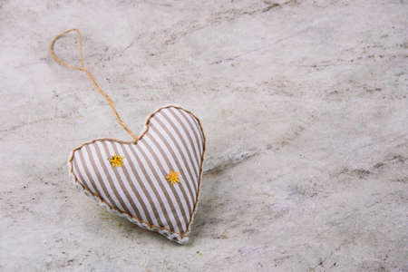 top view soft toy in a shape of heart on a marble background copy space