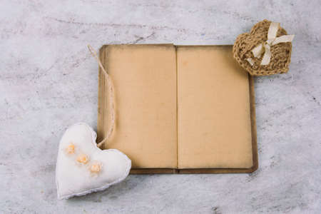 top view notebook with old vintage paper and stuffed toys heartsの写真素材