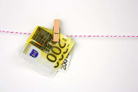 euro bills with clothespins hang on a ropeの写真素材