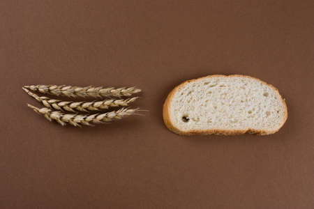 top view bread slice and ears on a brown background
