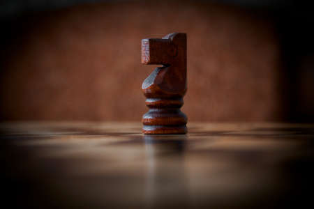 close up of a chess piece on the board, dark photo, vignette