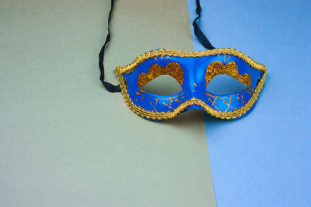 blue carnival mask on green and blue background