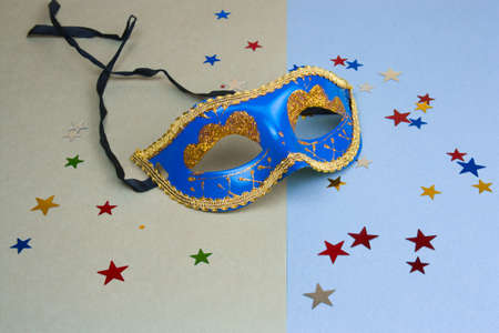 blue carnival mask and star glitters on green and blue backgroundの写真素材