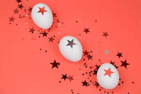 top view easter eggs and shiny star shaped glittersの写真素材