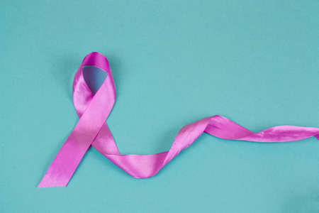 pink satin ribbon on a blue backgroundの写真素材