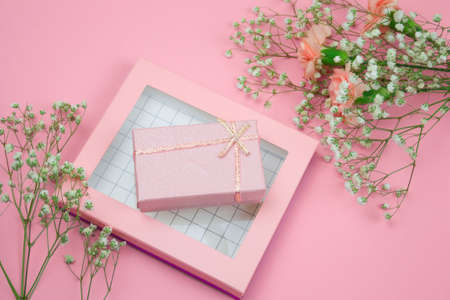 top viewpink gift box and flowers on a pastel pink backgroundの写真素材